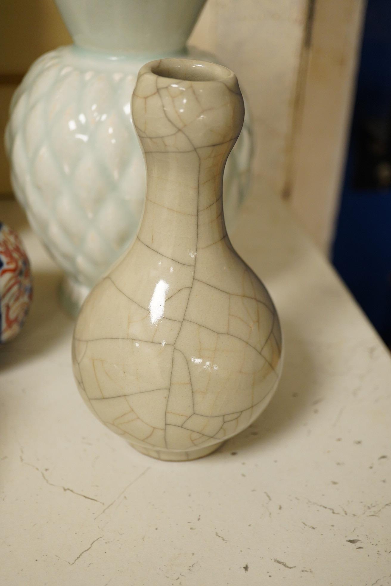 A Chinese Canton pattern vase, crackle glazed bottle vase, pale green vase, a Japanese Imari bottle vase and another cover, famille rose vase 24cm high. Condition - poor to good